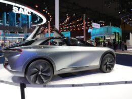 a silver car is on display at a show