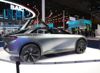 a silver car is on display at a show