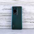 Back of a dark green smartphone with camera