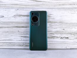 Back of a dark green smartphone with camera