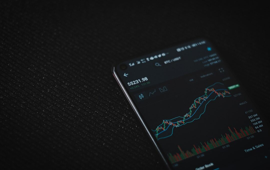 black android smartphone on black textile