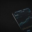 black android smartphone on black textile