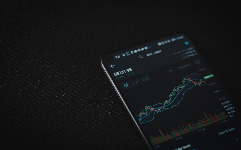 black android smartphone on black textile