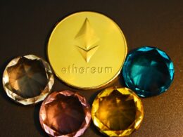 three different colored diamonds next to a gold coin