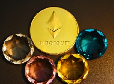 three different colored diamonds next to a gold coin