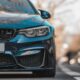 blue bmw car on road during daytime