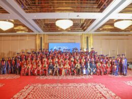 Graduation ceremony with many happy graduates.
