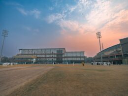 Cricket stadium with floodlights at sunset