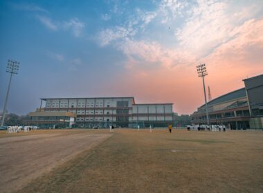 Cricket stadium with floodlights at sunset