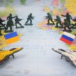 Toy soldiers and jets on map with flags.