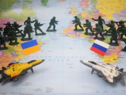 Toy soldiers and jets on map with flags.