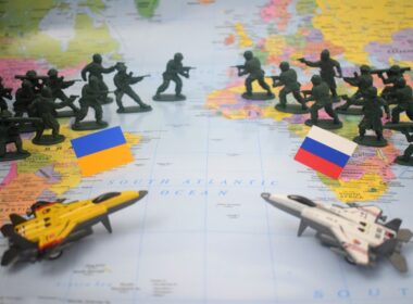 Toy soldiers and jets on map with flags.