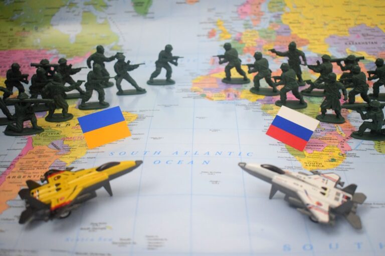 Toy soldiers and jets on map with flags.