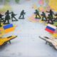 Toy soldiers and jets on map with flags.