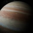 Jupiter with swirling clouds in dark space