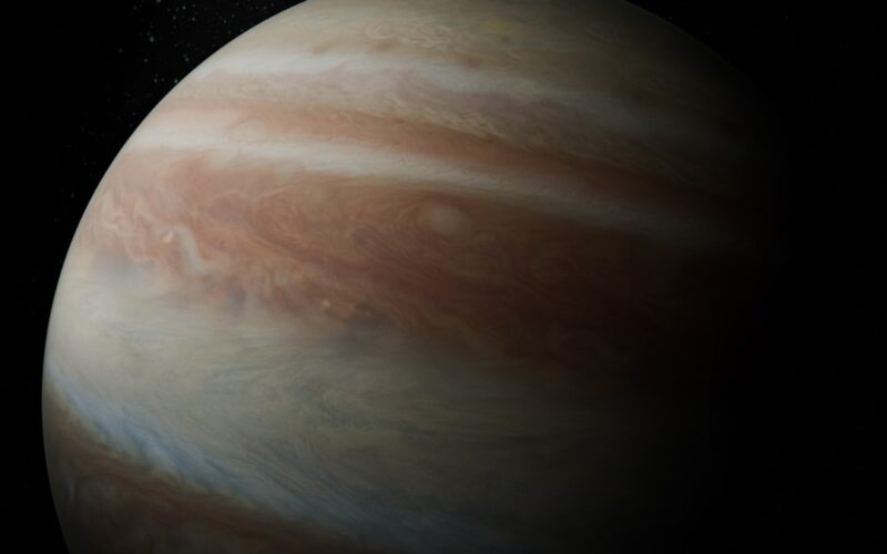 Jupiter with swirling clouds in dark space