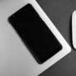 a cell phone next to a mouse