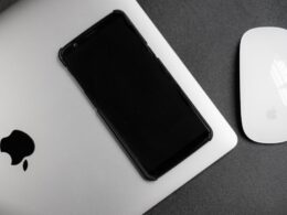 a cell phone next to a mouse
