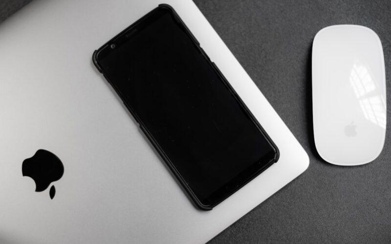 a cell phone next to a mouse