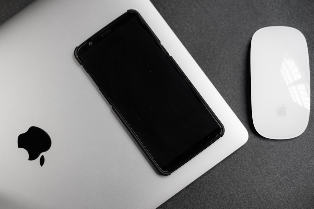 a cell phone next to a mouse