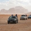 black car on brown sand during daytime