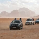 black car on brown sand during daytime