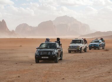 black car on brown sand during daytime