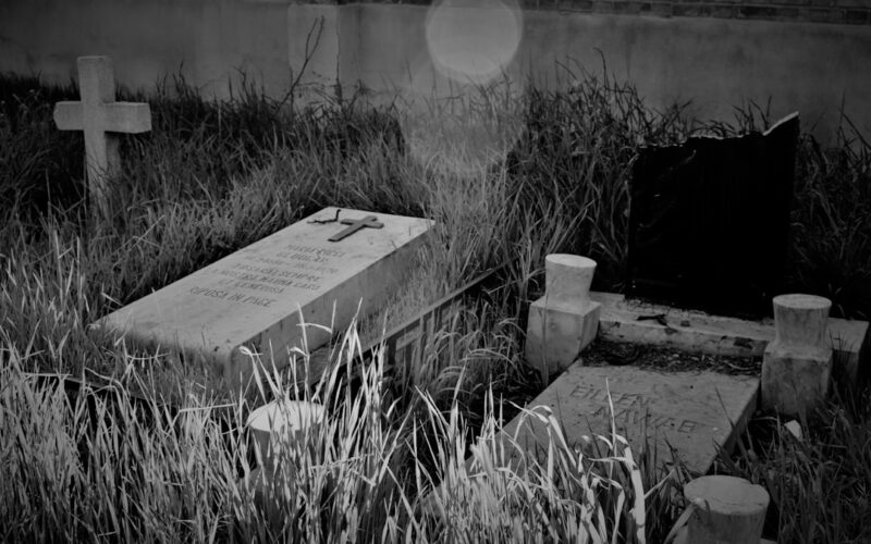 a black and white photo of a cemetery