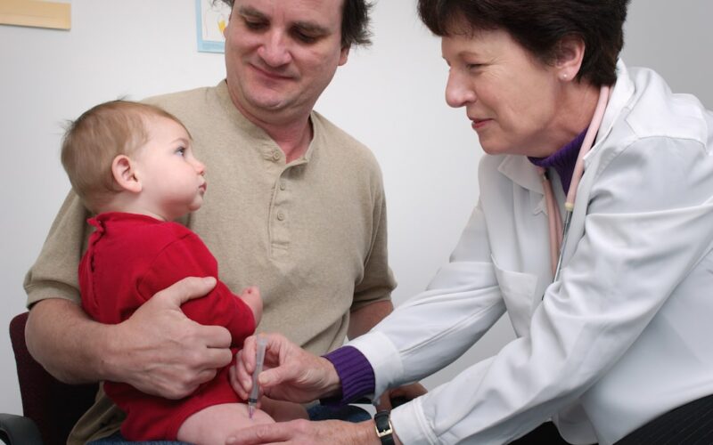 a doctor examines a baby's chest with a stethoscope