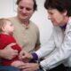 a doctor examines a baby's chest with a stethoscope