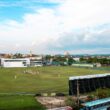 Cricket match is in progress at a stadium.