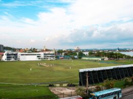 Cricket match is in progress at a stadium.