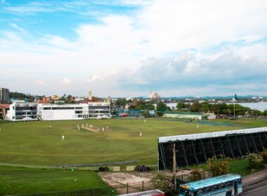 Cricket match is in progress at a stadium.