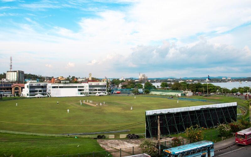 Cricket match is in progress at a stadium.