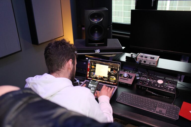 a man sitting in front of a laptop computer