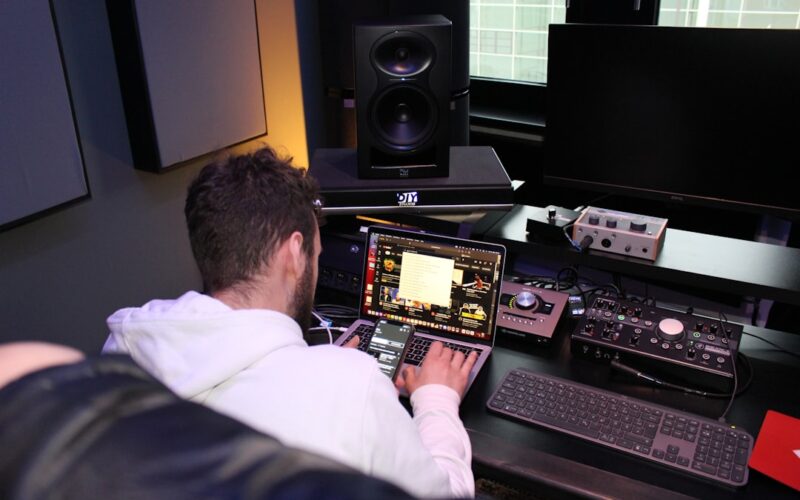 a man sitting in front of a laptop computer