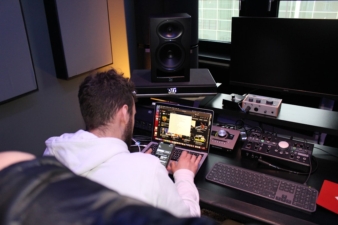 a man sitting in front of a laptop computer