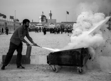 a man pulling a cart with a lot of smoke coming out of it