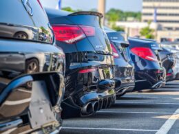 a row of parked cars in a parking lot