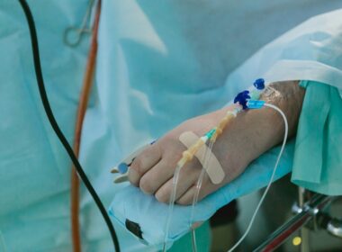 a person in a hospital bed with an iv