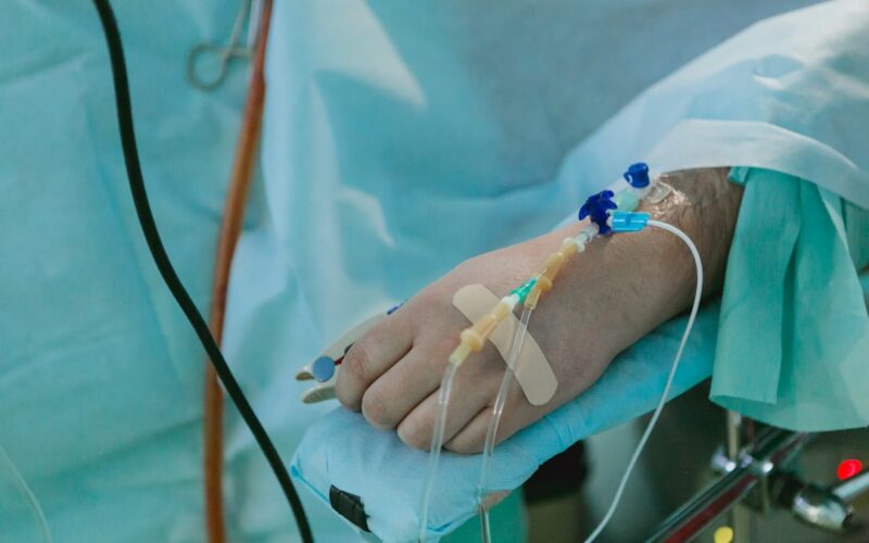 a person in a hospital bed with an iv