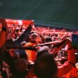 A large group of people sitting in a stadium
