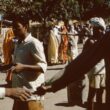 a group of people standing around each other