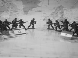 Toy soldiers in formation with flags on world map
