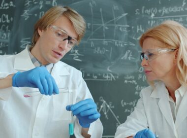 Scientists in lab coats working with test tubes
