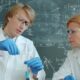 Scientists in lab coats working with test tubes