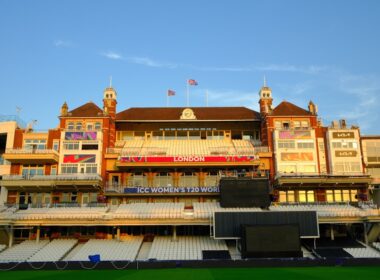 Ornate cricket stadium building with empty seats.