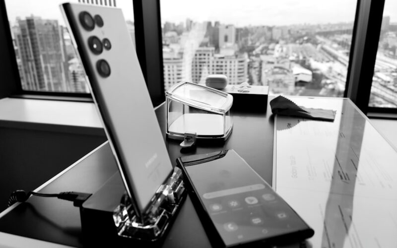 a table with a cell phone and a remote control on it