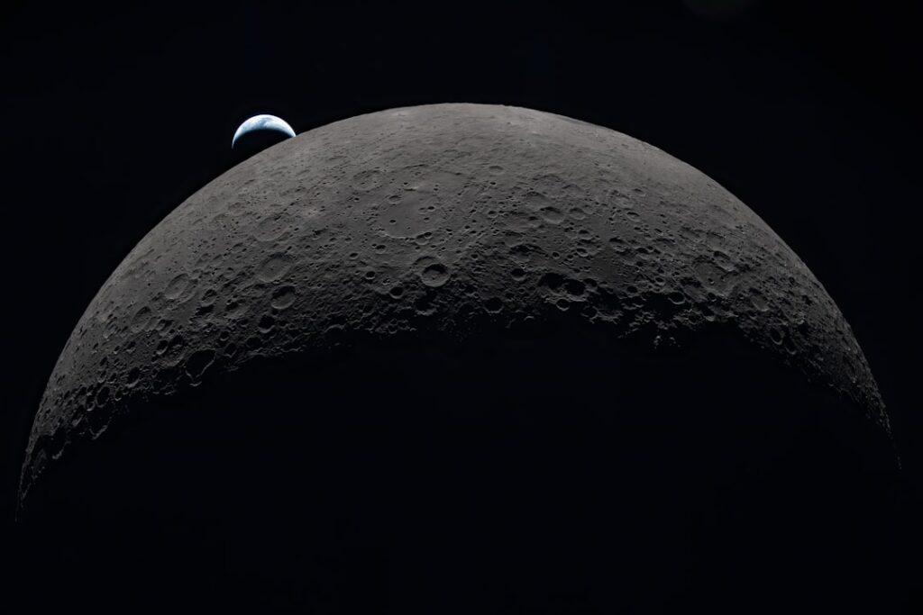 Earth rising over the moon's horizon