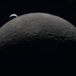 Earth rising over the moon's horizon